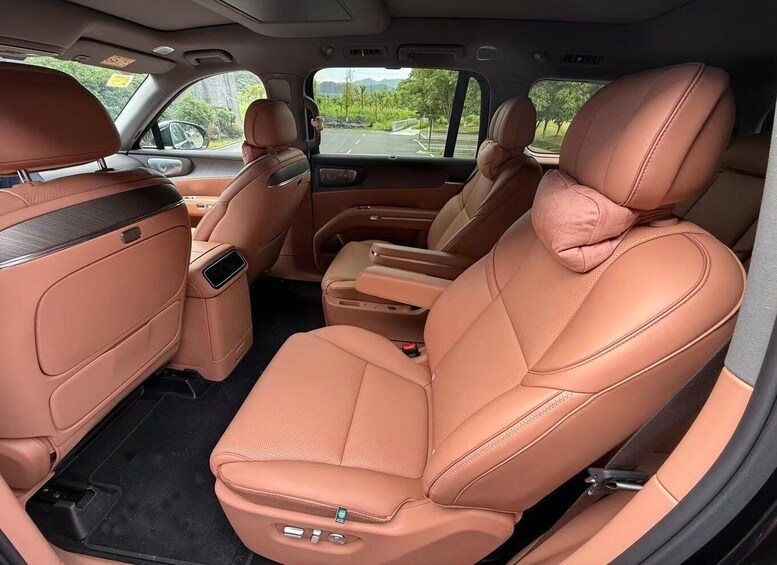 A car's interior with tan leather seats and a center console. 3