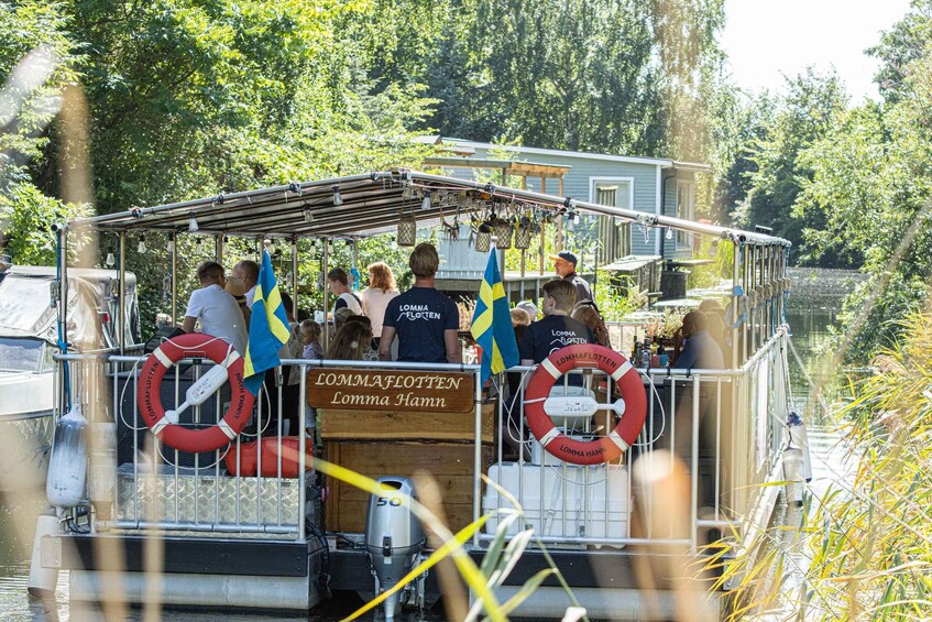 A boat with people, life rings, and Swedish flags. 5