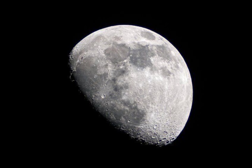 A detailed view of the moon's surface with visible craters and lunar maria. 1