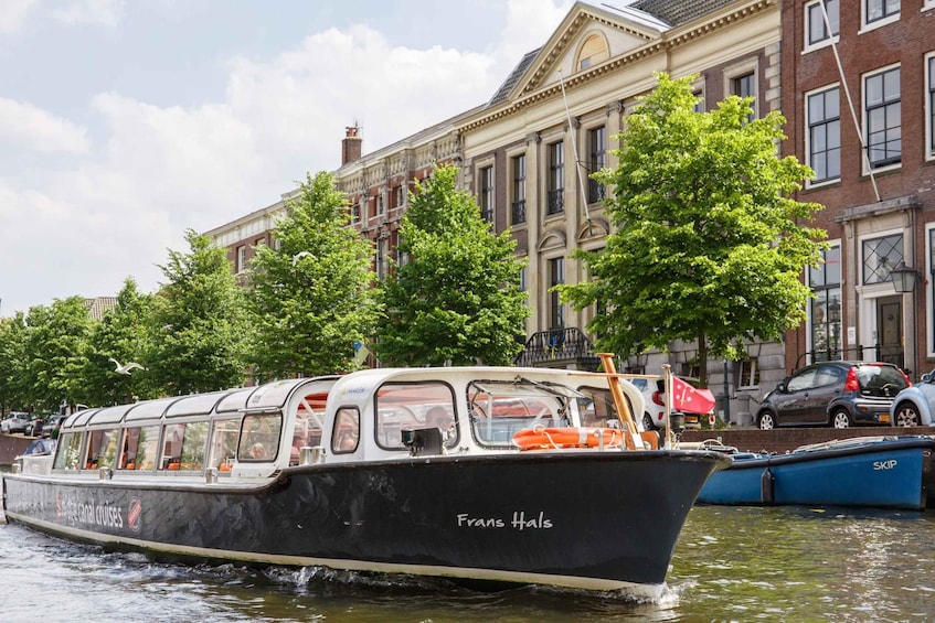 A boat named 'Frans Hals' on a canal with buildings and trees in the background. 4