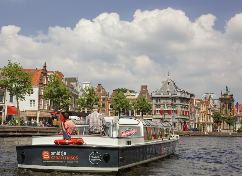 A boat named 'Smidtje' cruising on water with a cityscape in the background. 5