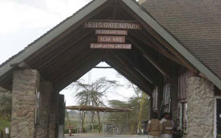 A stone building with a sign reading 'HELLS GATE PARK HEADQUARTERS' and 'ELSA GATE A Walk on the Wild Side.' 3