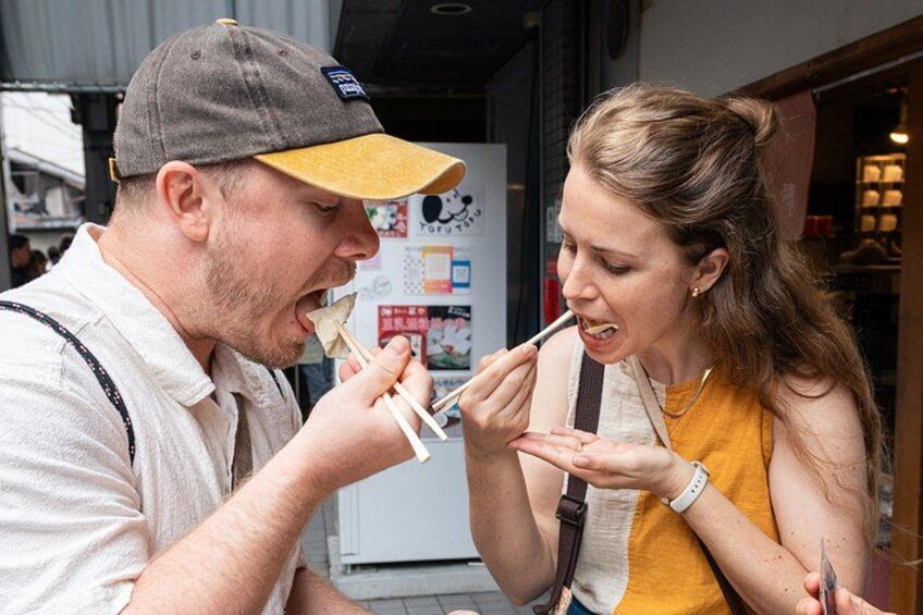 Two people eating ice cream cones outdoors. 3