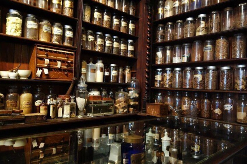 A pantry with shelves of glass jars containing various food items. 2