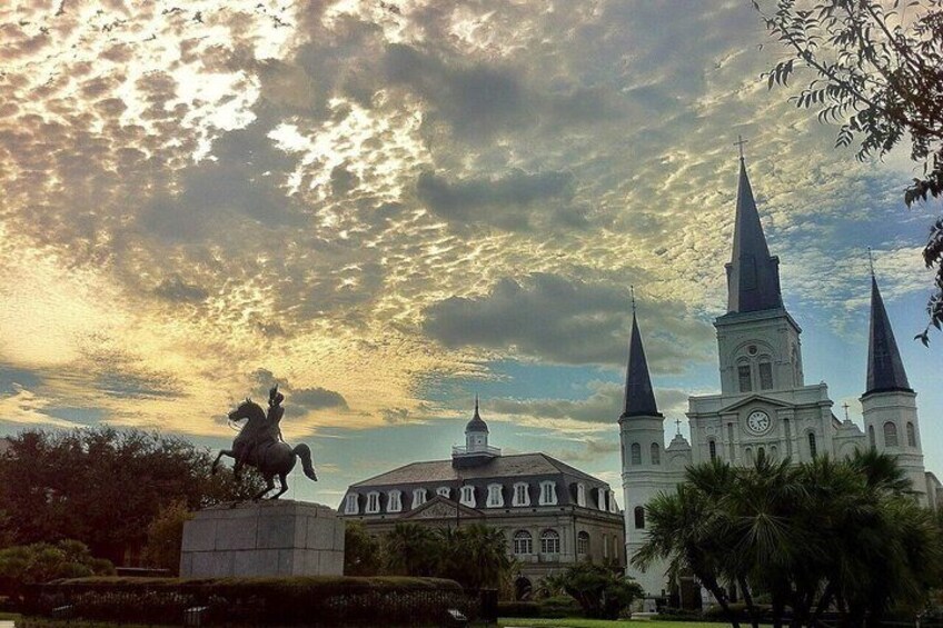 A statue, a church, and a building with a dome. 3