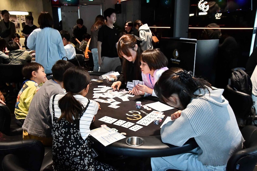 A group of people playing a card game at a casino table. 1