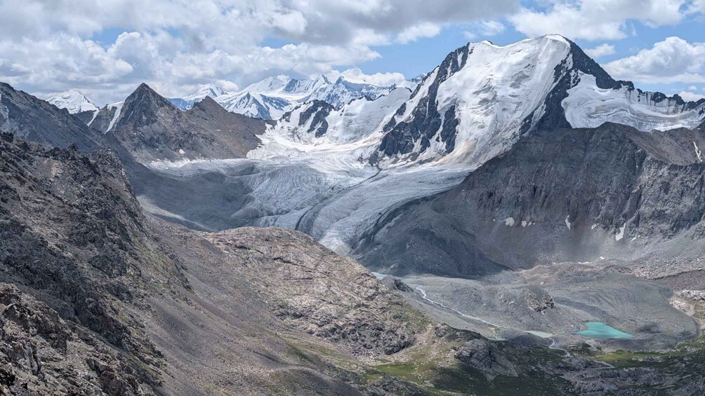 A glacier valley with rugged mountains and a turquoise lake. 3