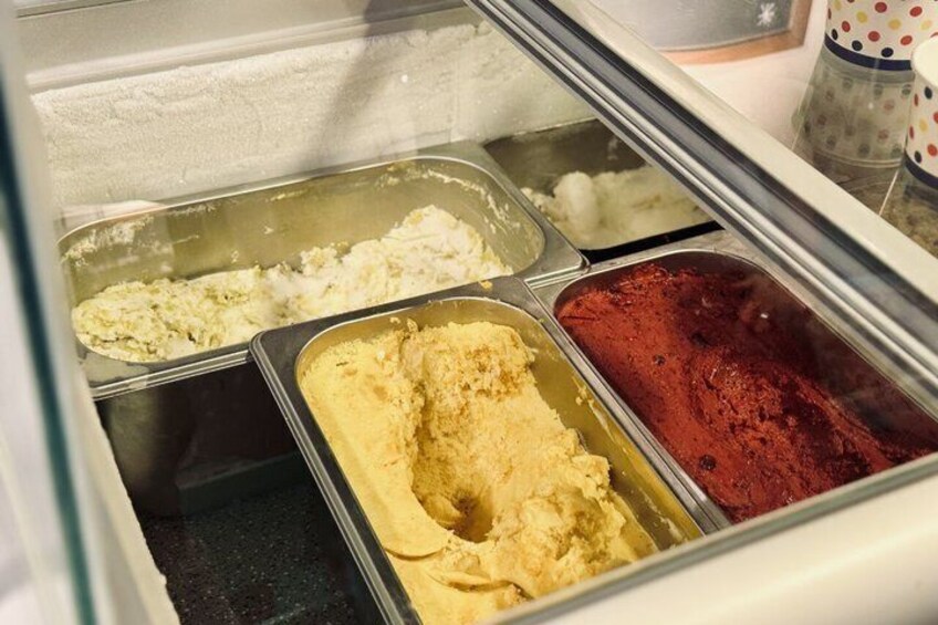 A display case with three ice cream containers. 2