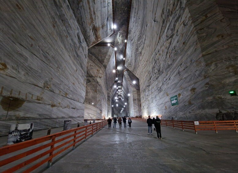 A large, open underground space with high ceilings and a central walkway. 4