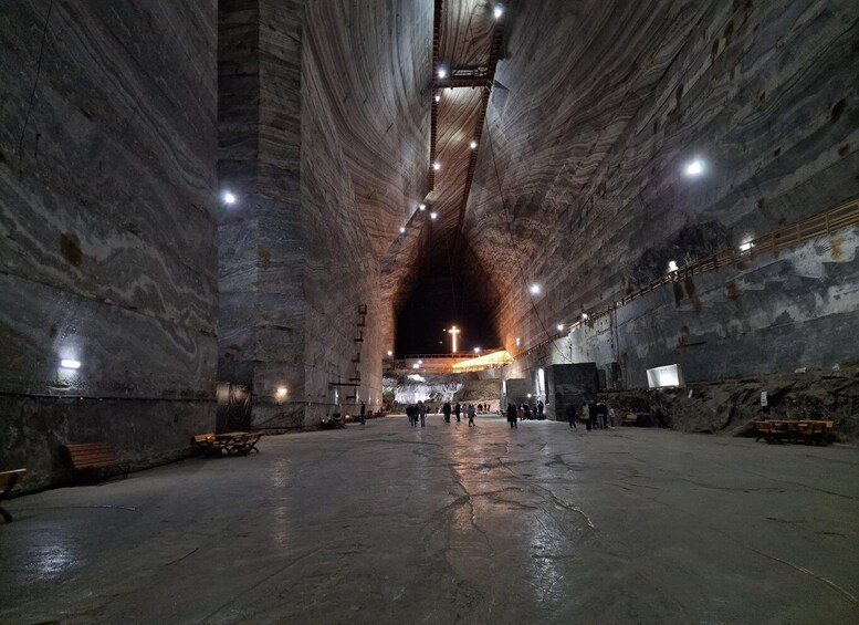 A large, cavernous interior with high ceilings and natural rock formations. 2