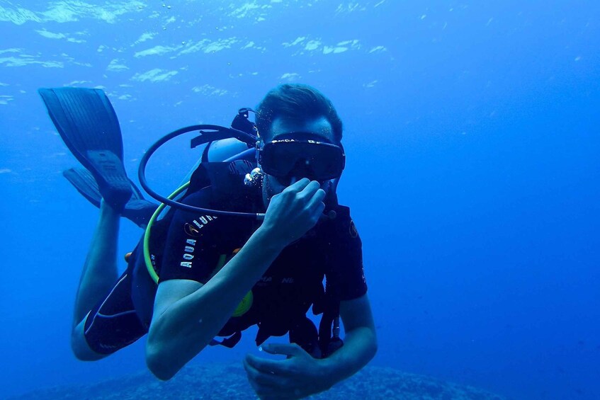A person scuba diving underwater. 4