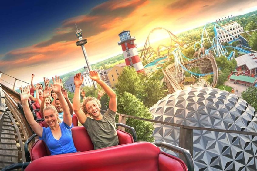 A roller coaster with riders in red cars, a Ferris wheel, and a distinctive geodesic dome structure. 1
