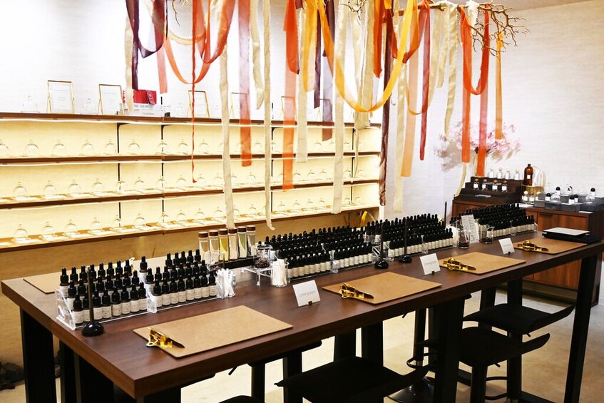 A wine tasting room with bottles and glasses on display. 3