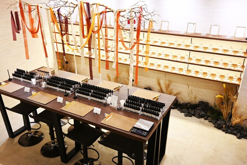 A tasting room with multiple rows of wine bottles and a display of wine glasses. 4