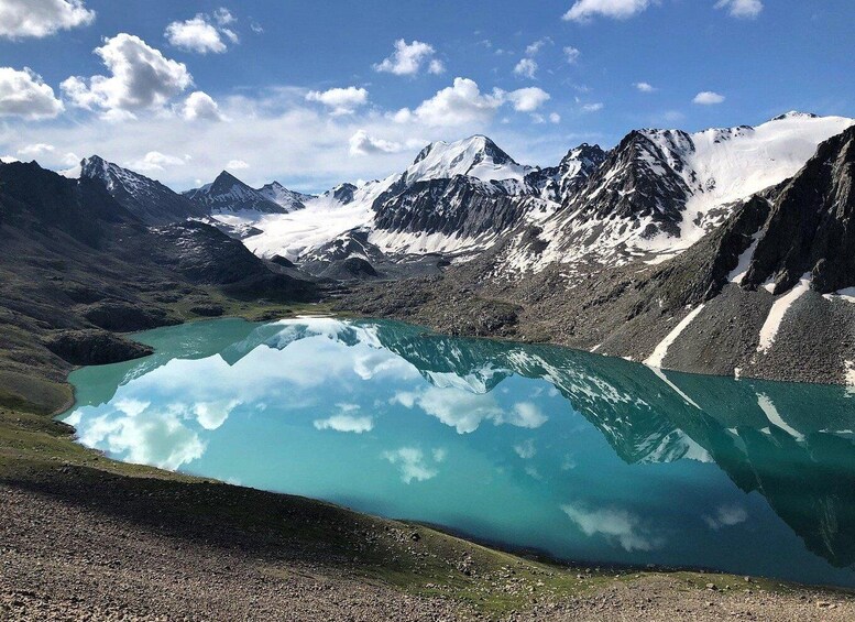 A mountain lake with clear reflections of the surrounding peaks. 1