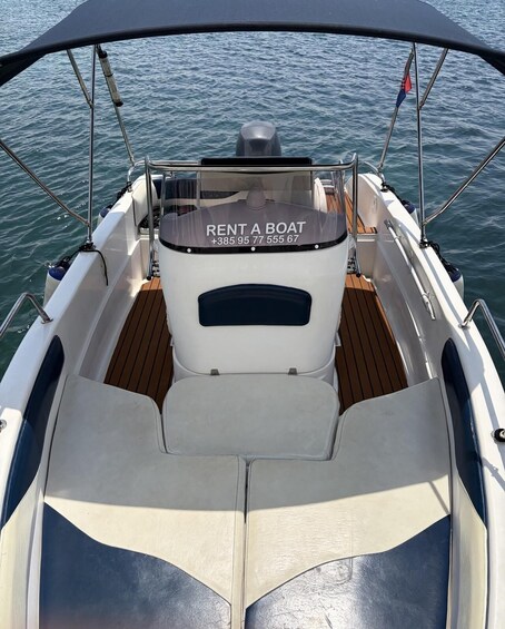 A boat's interior with a 'RENT A BOAT' sign and contact number. 3