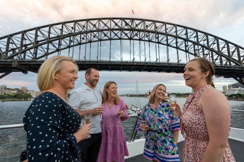 A group of people on a boat with a bridge in the background. 5