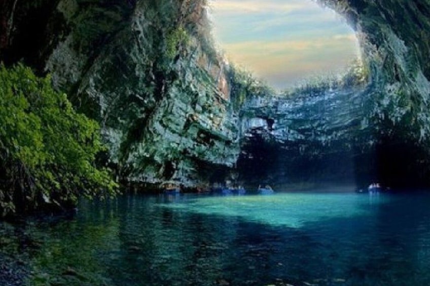 A natural cave opening with water inside. 2