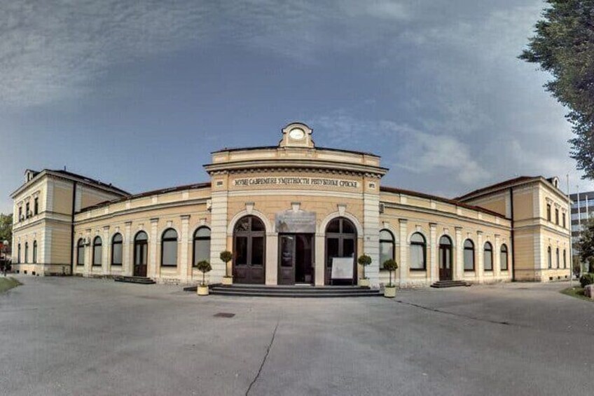 A large, historic building with arched windows and a central entrance. 2