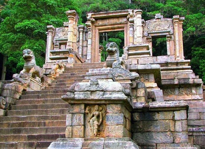 A stone staircase with intricate carvings and lion statues leading up to a temple entrance. 4