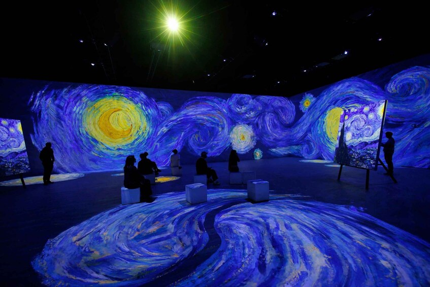 A room with a large, swirling, colorful painting on the wall and a floor that mimics the painting's style. 4