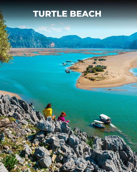 A scenic view of Turtle Beach with clear turquoise waters, rocky shoreline, and boats docked near the beach. 4