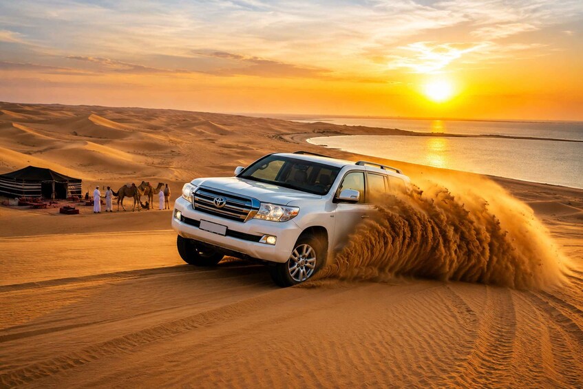 A white SUV driving through sand dunes with a sunset in the background. 5