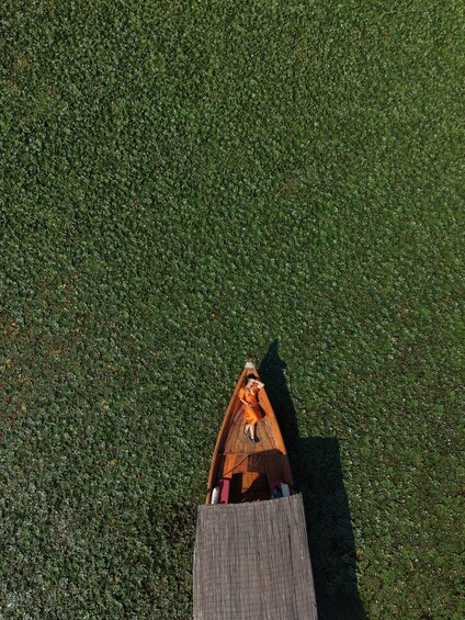 A small wooden boat on a body of water. 1