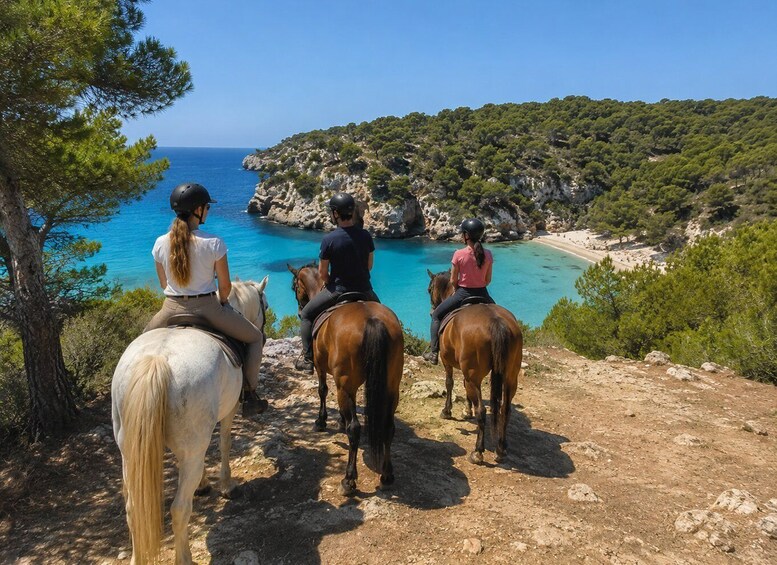 Three people riding horses on a rocky path overlooking a turquoise sea and a coastal landscape. 1