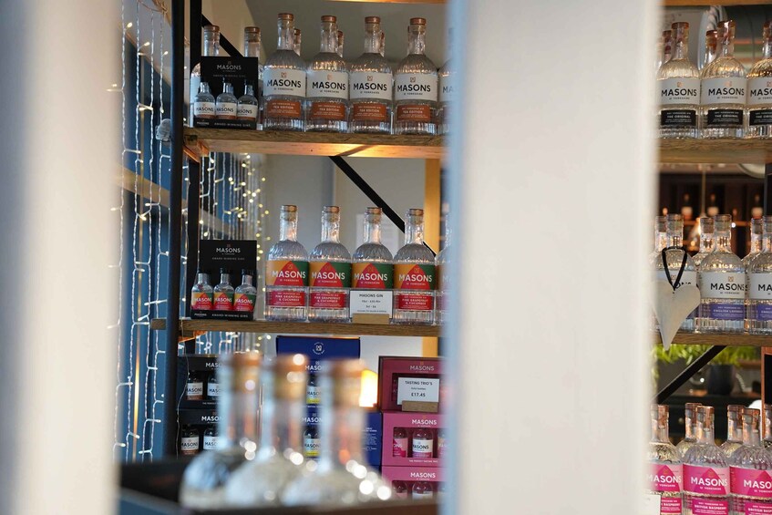Shelves stocked with Mason's gin bottles and boxes. 5