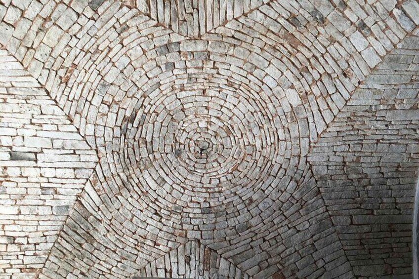 A circular brick pattern on a wall. 5