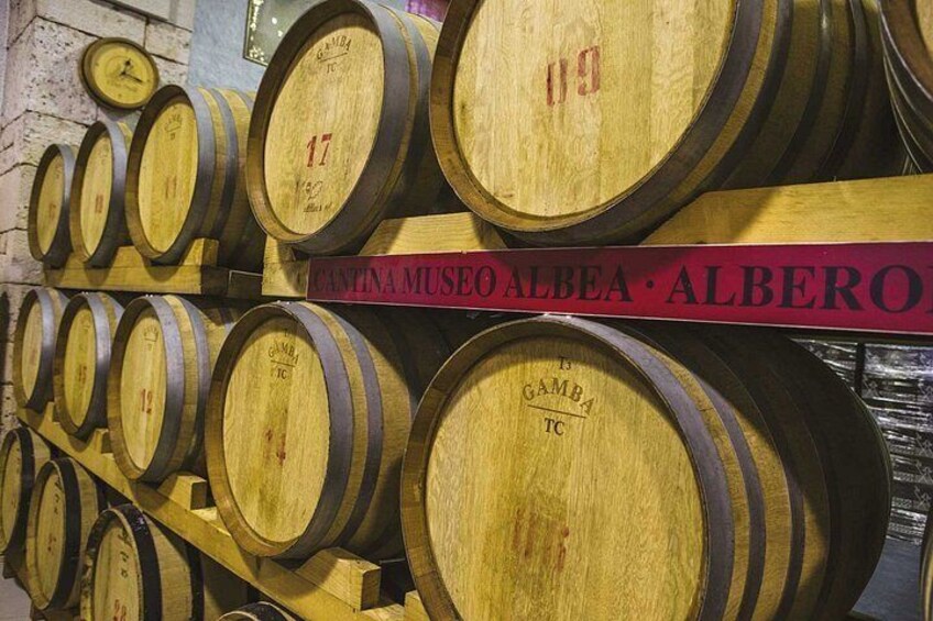 Wooden barrels stacked in a warehouse. 4