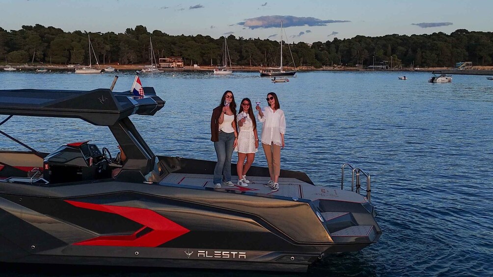 A jet ski with three people on it, a body of water, and a forested shoreline in the background. 4