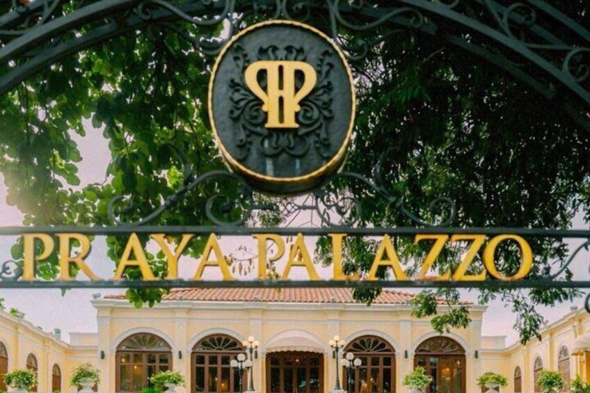 The entrance to Praya Palazzo with a prominent sign and ornate ironwork. 5
