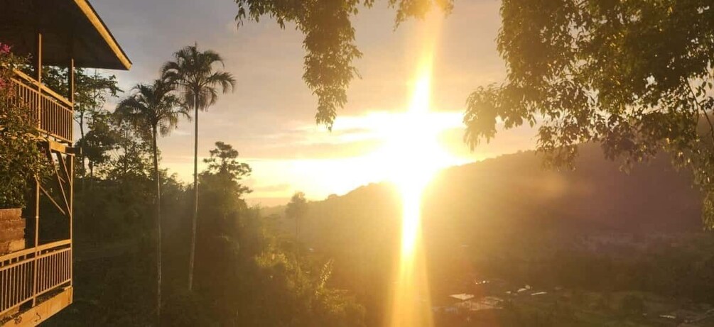 A sunset over a landscape with a wooden structure on the left. 2