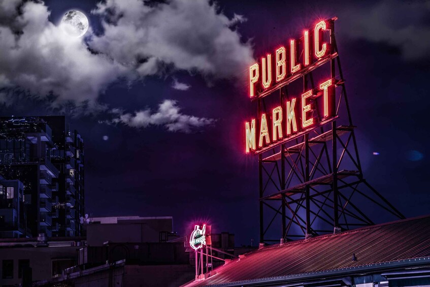 A night scene with a large illuminated 'PUBLIC MARKET' sign against a backdrop of a full moon and clouds. 3