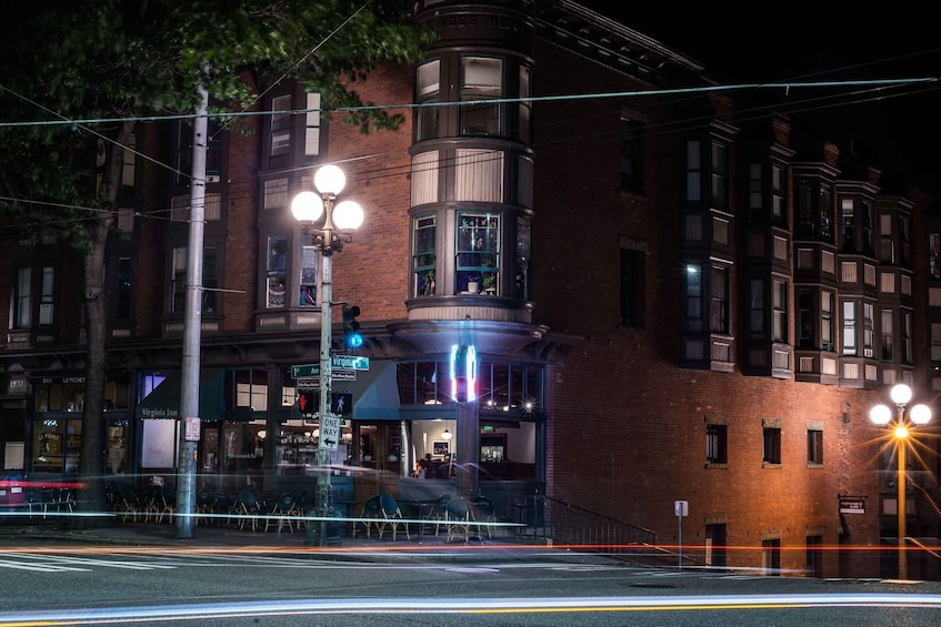 A nighttime street scene with a corner building, street lamps, and a 'Virginia Inn' sign. 4