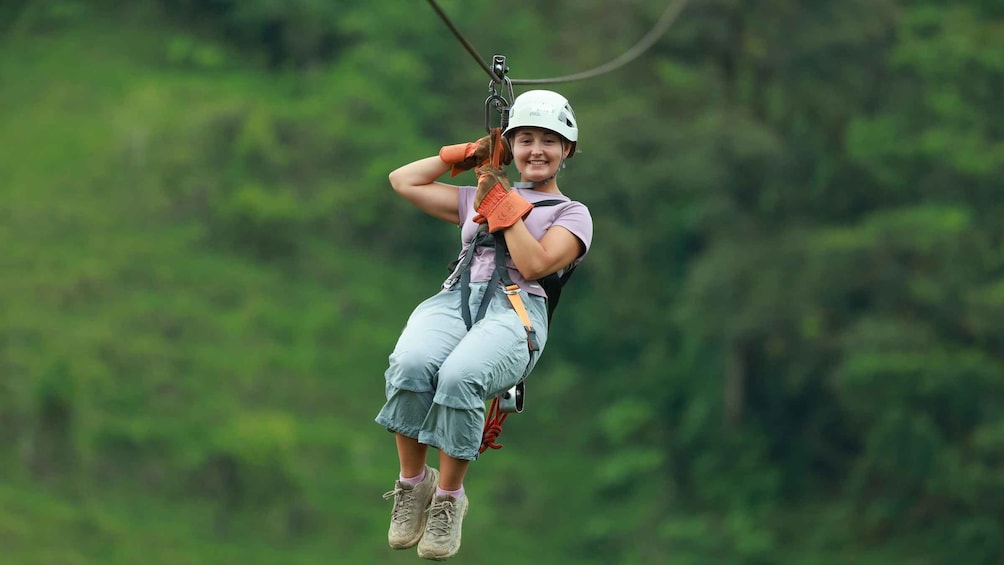 A person zip-lining through a forest. 3