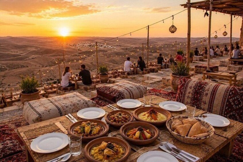 A table set for a meal with dishes and a sunset view. 5