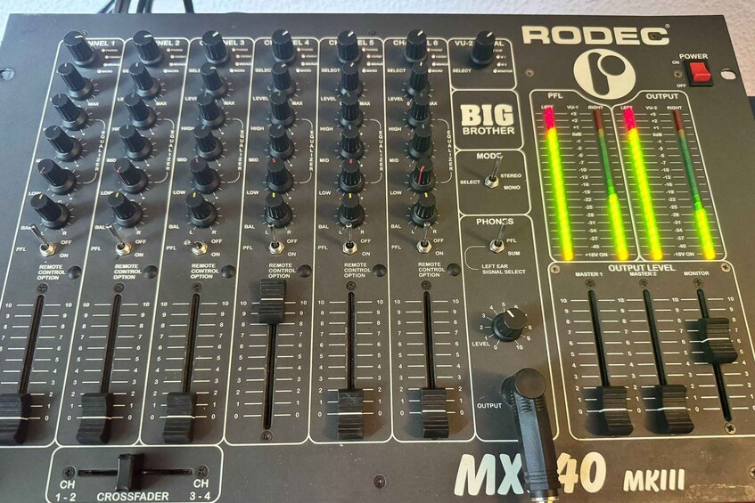 A RODEC MX 40 MKIII audio mixer with multiple channels, knobs, and meters. 4