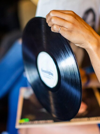 A hand holding a vinyl record. 2