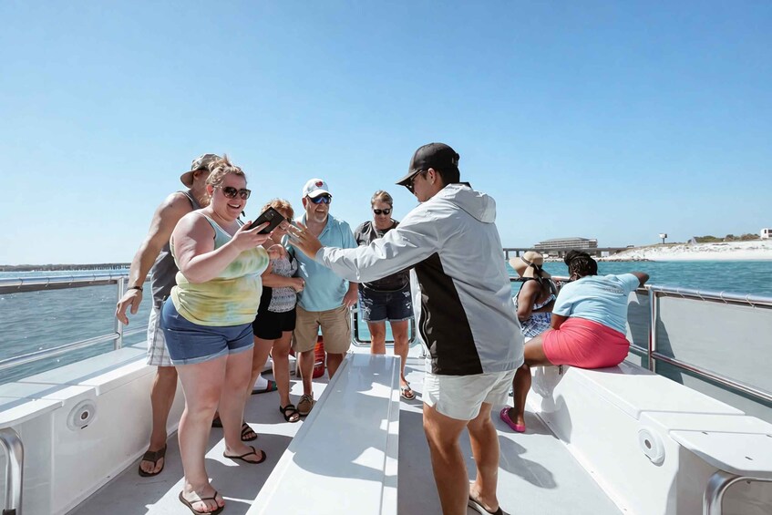 People on a boat with a clear sky and water in the background. 4