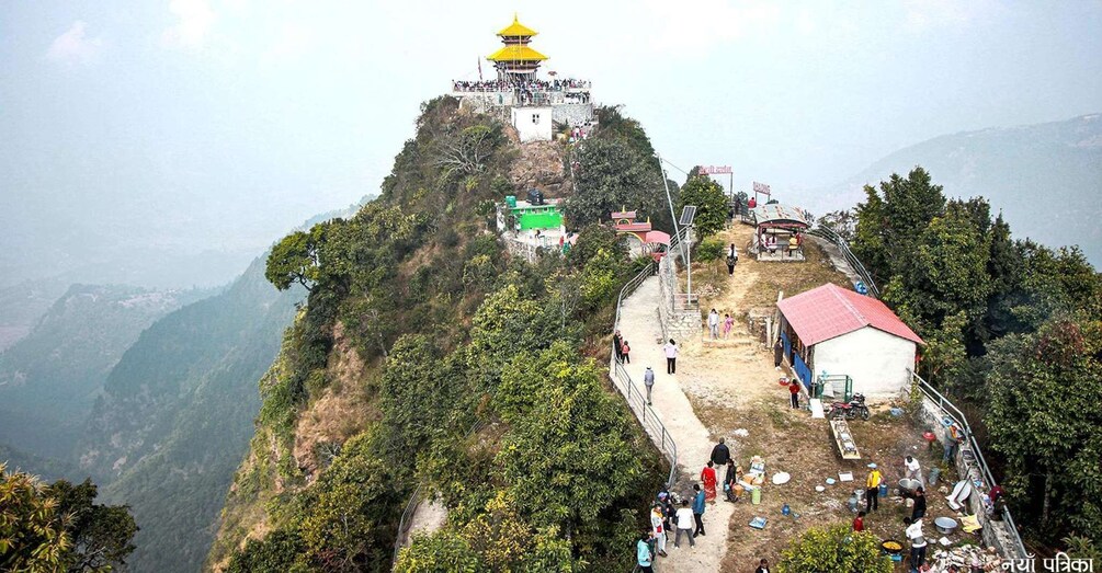 A mountain peak with a yellow pagoda, a dirt path, and a small building with a red roof. 1
