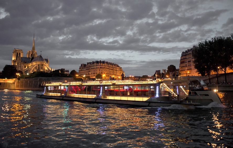 A river with a boat, a cathedral, and a building reflecting on the water. 3