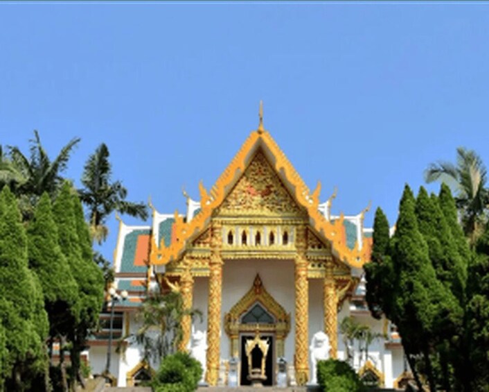 A traditional Thai temple with ornate golden decorations and a pointed roof. 3