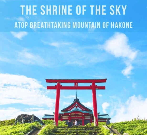 A shrine with a red torii gate, surrounded by lush greenery and a clear blue sky. 4