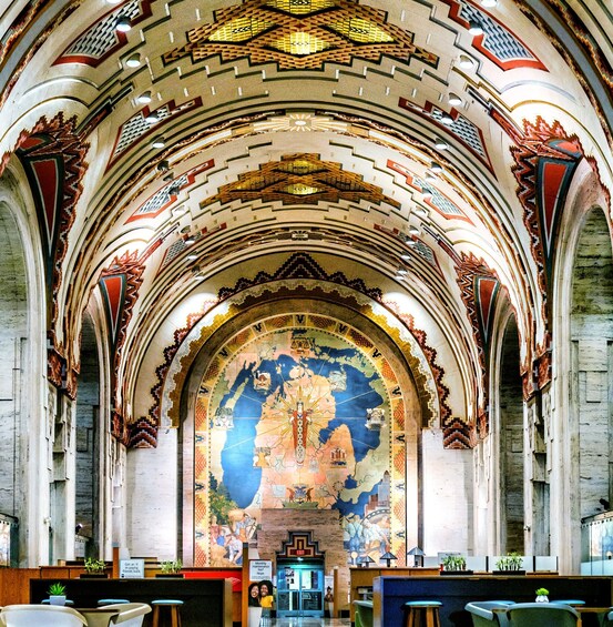 A church interior with a large mural depicting a map and religious figures. 1