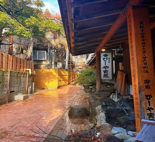 A traditional Japanese building with a wooden entrance and a stone pathway leading to it. 4