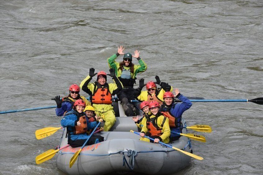 A group of people in a raft on a river. 1
