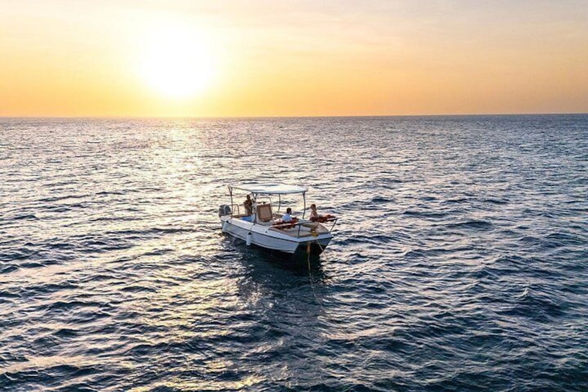 A boat on calm waters during sunset. 4